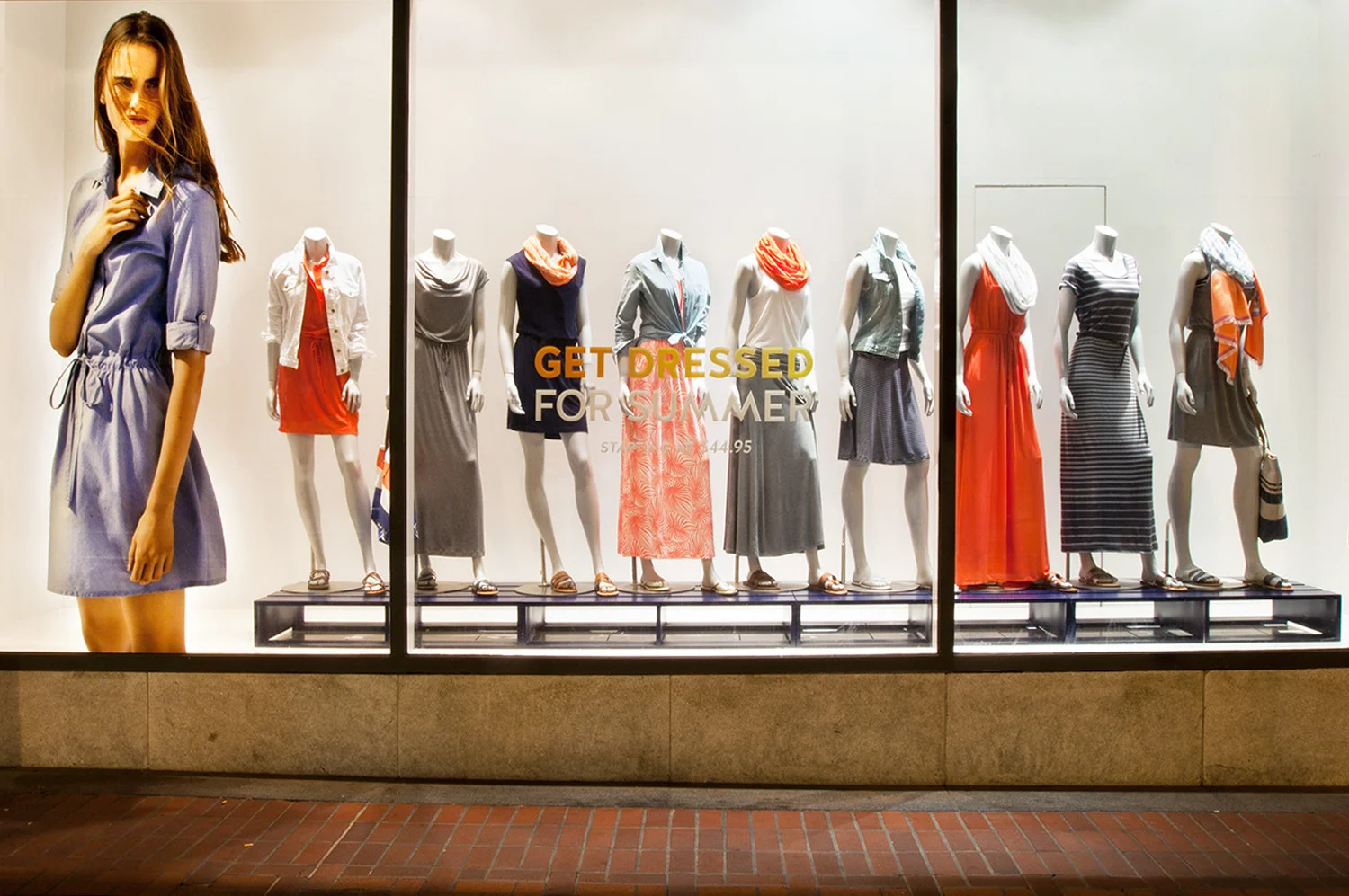 A retail-style selection of summer dresses presented as a seasonal dress shop assortment