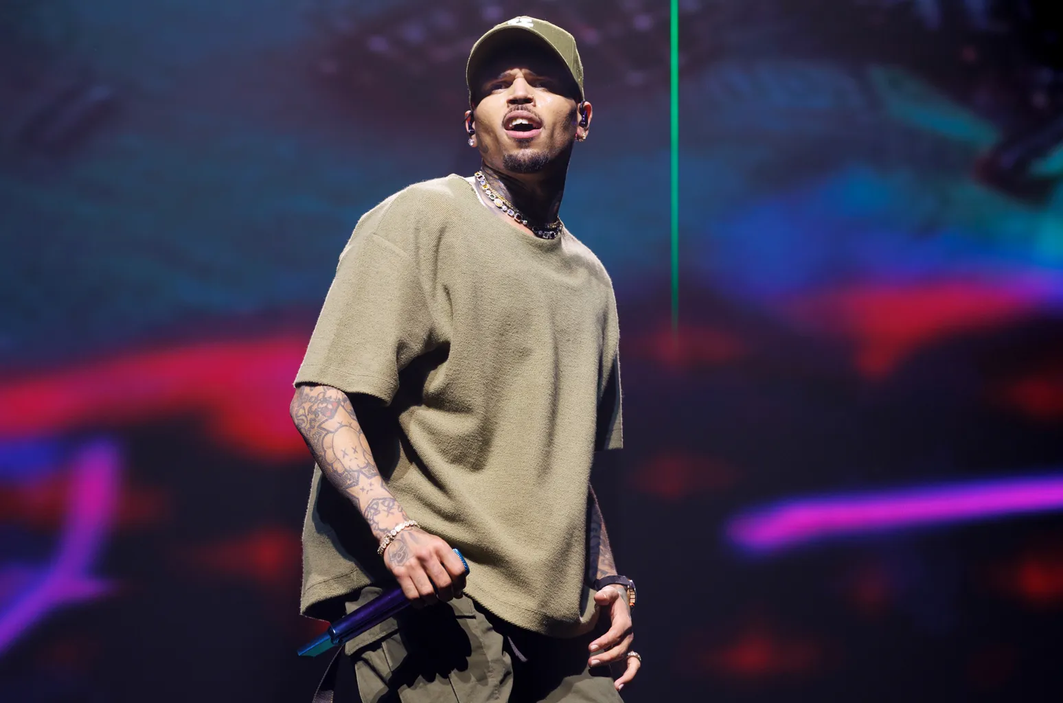 Chris Brown at a public appearance wearing a fashion-forward outfit, photographed by press