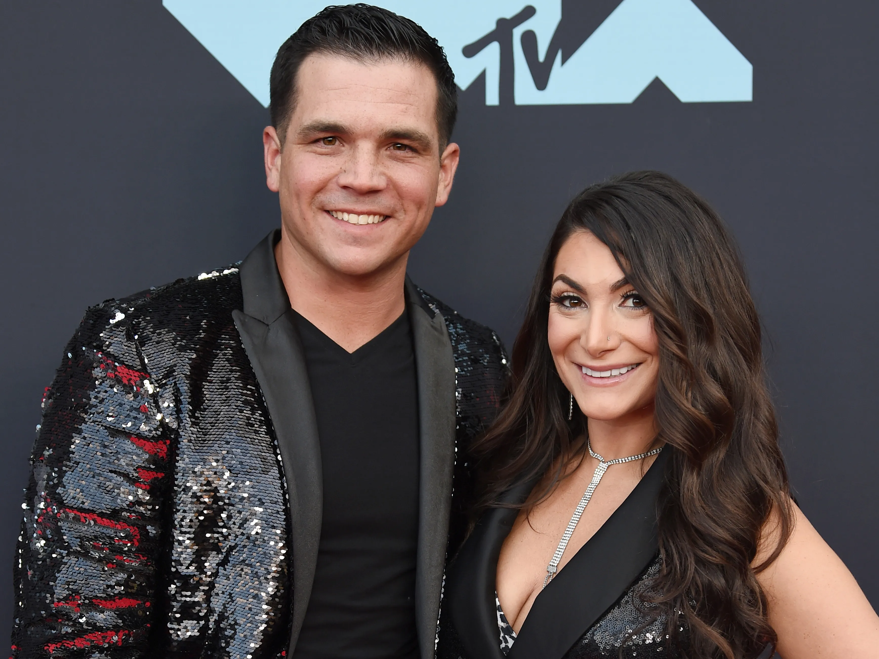 Deena Cortese smiles while posing at an event