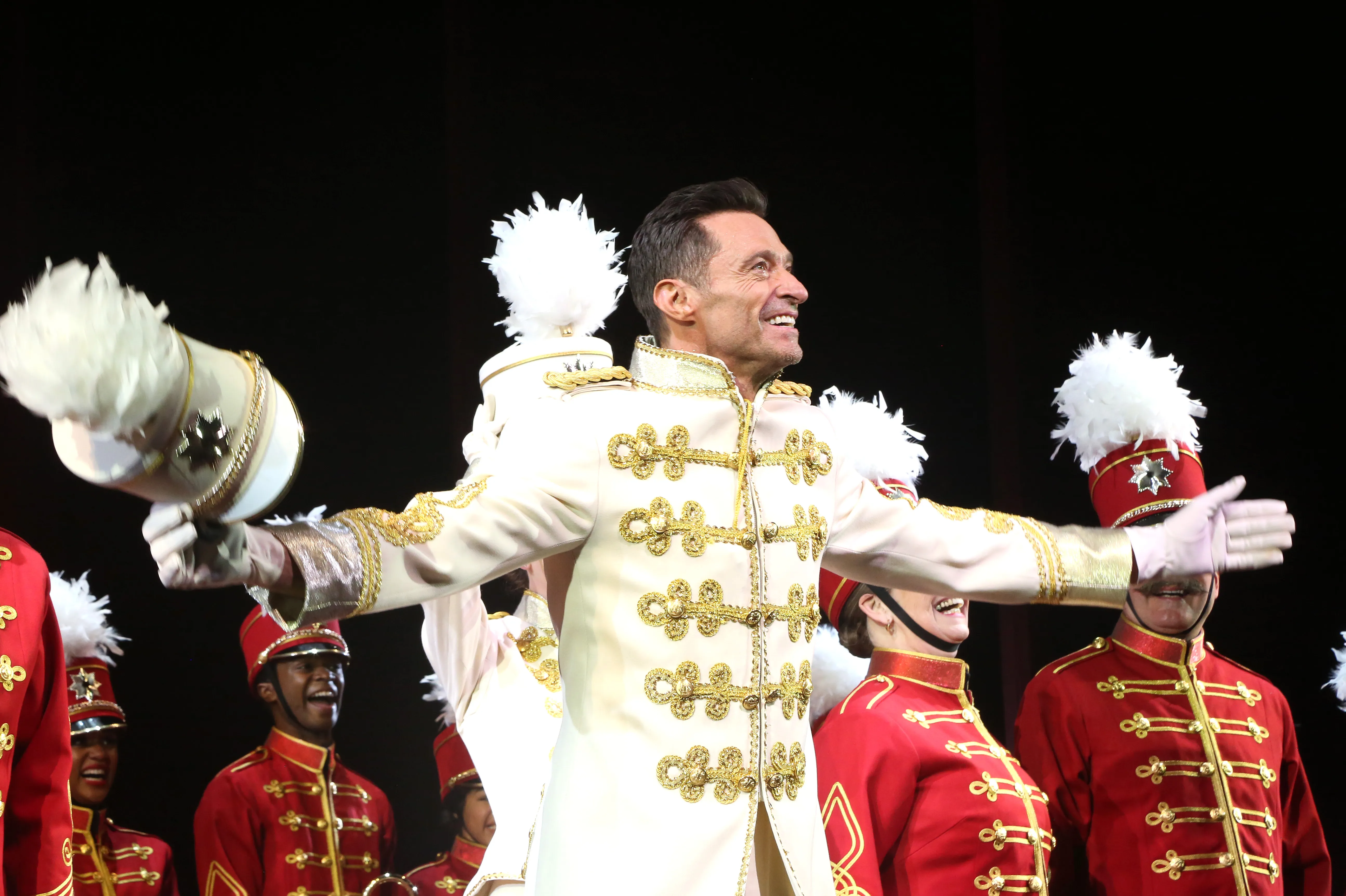 Hugh Jackman greeting fans near a Broadway theater stage door.