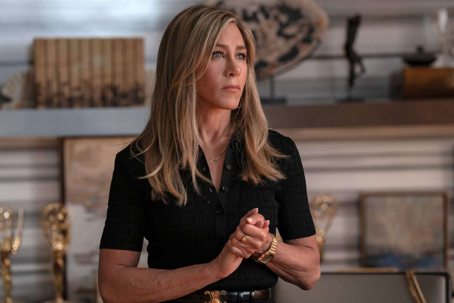 Jennifer Aniston attending an event connected to a film or television project, smiling and facing photographers.