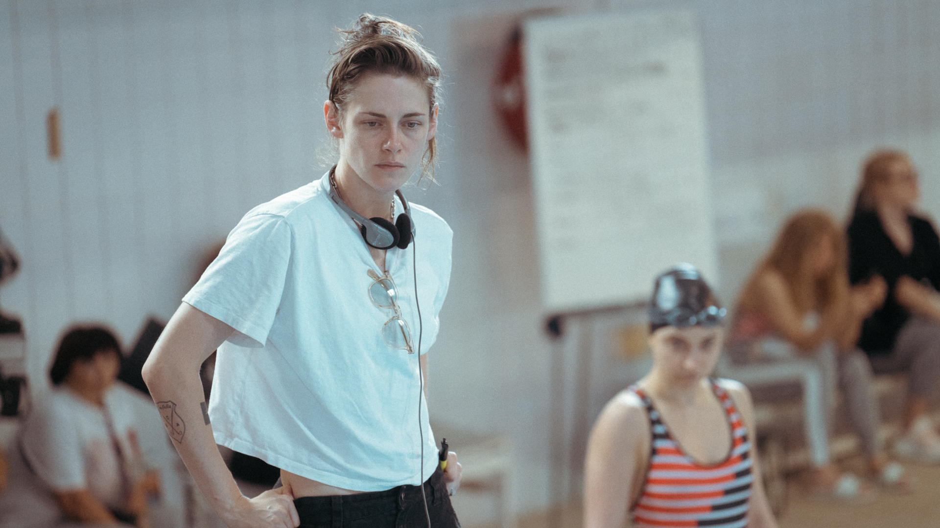 Kristen Stewart photographed outdoors in natural light, wearing a casual jacket and looking thoughtfully to the side