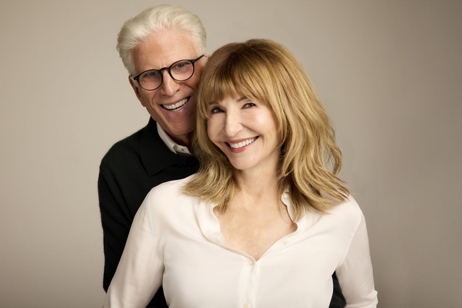 Ted Danson and Mary Steenburgen smile together at a public event as they pose side by side